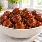 Barbecue cola meatballs coated in a glossy tomato-based sauce with onion and green pepper
